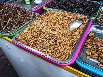 At a street market in bangkok, thailand, you'll find delicious offerings of insects and maggots.