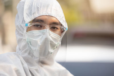 Medical scientist in ppe uniform wearing a face mask protective person