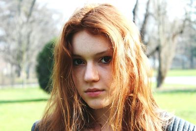 Portrait of beautiful woman on grassy field