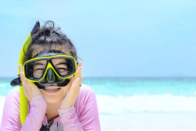 Portrait of boy in sea against sky