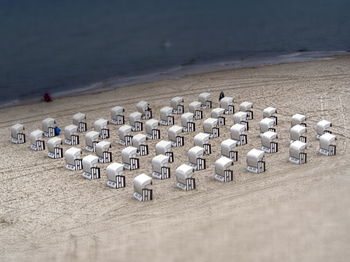 Row of chairs on sand at beach
