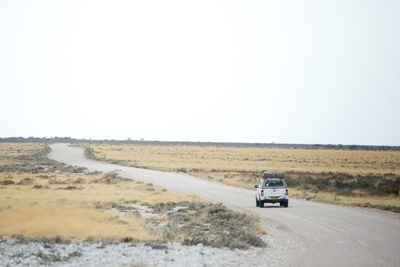 Car on road against clear sky