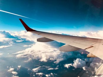 Aerial view of airplane flying in sky