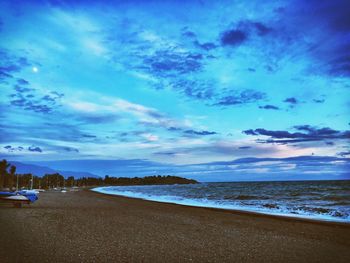 Scenic view of beach against blue sky