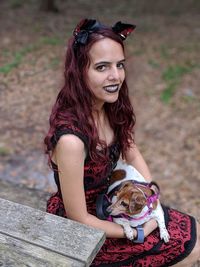 Portrait of a smiling young woman sitting outdoors