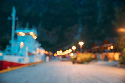 Defocused image of illuminated city street at night