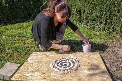 Full length of woman preparing food on table