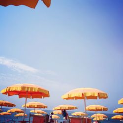 Beach umbrellas against clear blue sky