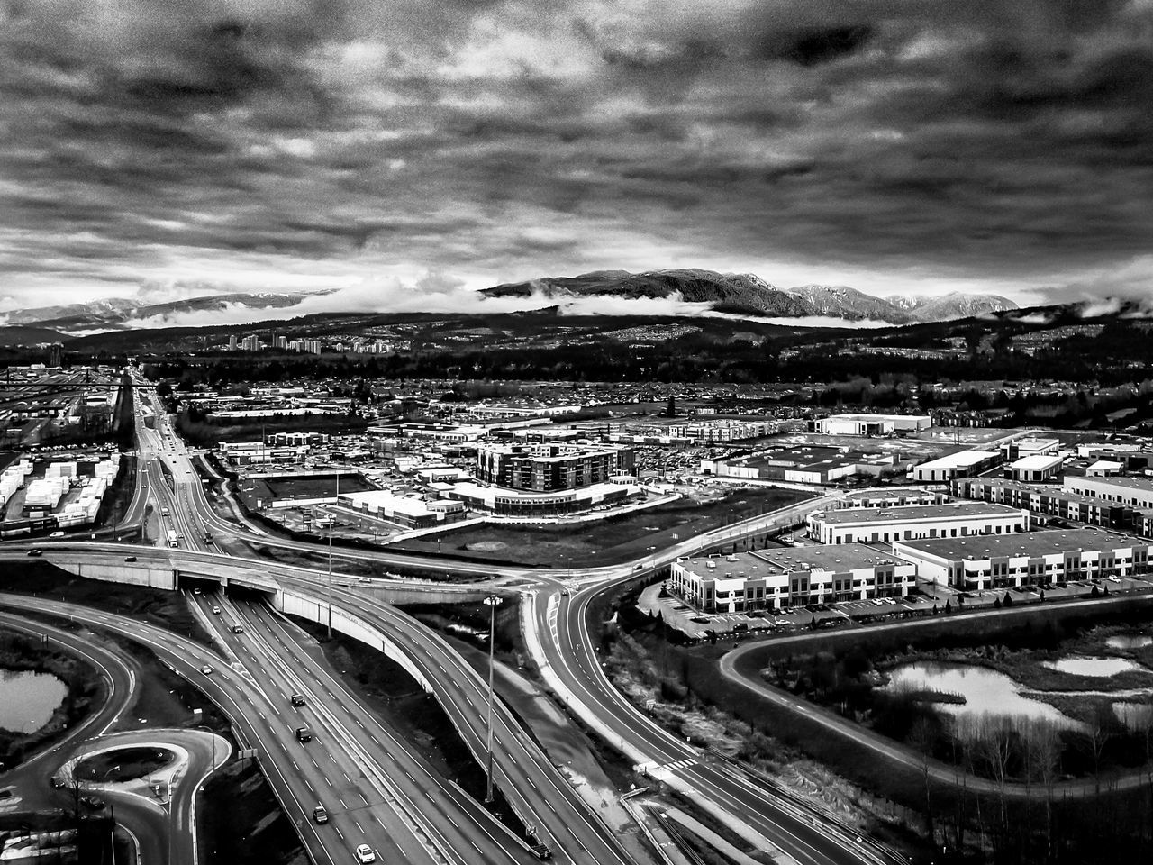 HIGH ANGLE VIEW OF ELEVATED ROAD AND CITYSCAPE