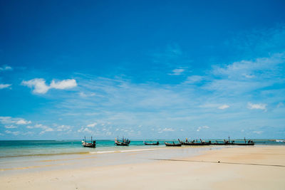 Scenic view of beach against blue sky