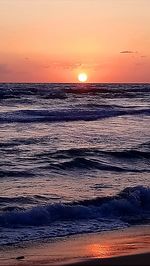 Scenic view of sea against romantic sky at sunset