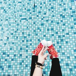 Woman standing by swimming pool