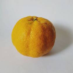Close-up of orange slice against white background