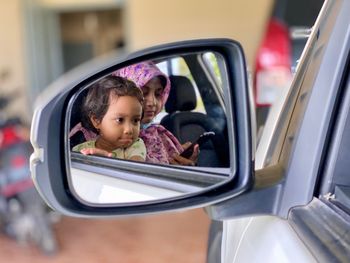 Portrait of a smiling woman sitting in car