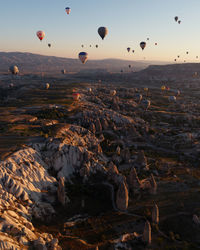 Hot air balloons flying over sea