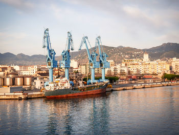 Cargo ship moored at the quay of the port of palermo on a sunny spring morning, italy