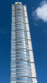 Low angle view of modern building against blue sky