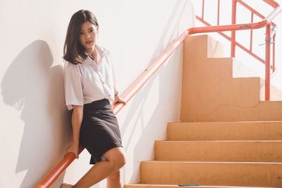 Young woman on staircase at home