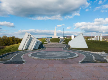 Footpath in park against sky