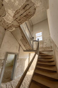 Low angle view of staircase in abandoned building