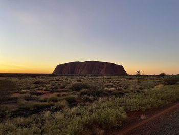 Scenic view of landscape against sky during sunset uluru 