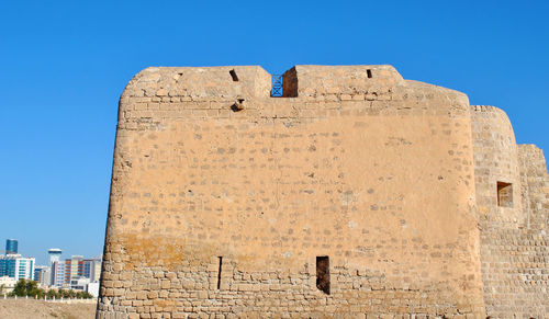 Low angle view of old building against blue sky