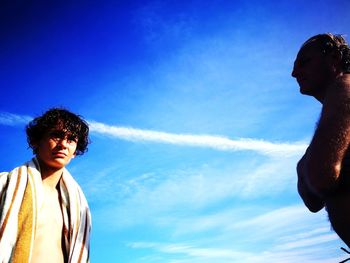 Portrait of young man standing against sky