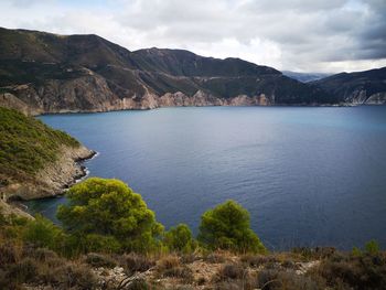 Scenic view of sea and mountains against sky