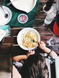 High angle view of woman holding drink in restaurant