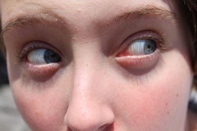 Cropped image of woman looking away on sunny day