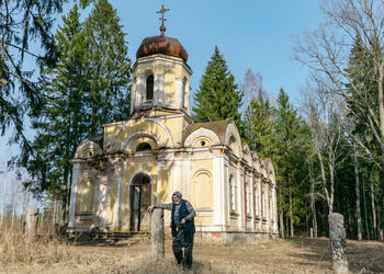 Rear view of man standing in front of church