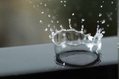 Close-up of water splashing in glass