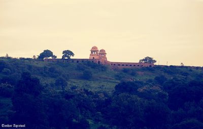 Castle on landscape against clear sky