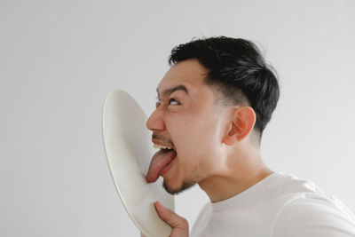 Portrait of young man against white background