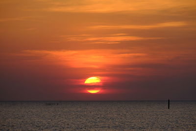 Scenic view of sea against romantic sky at sunset