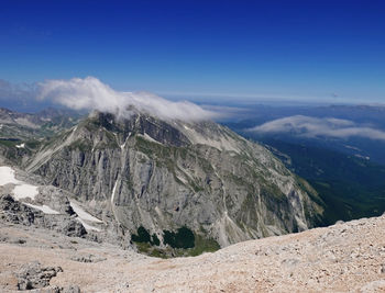 Scenic view of snowcapped mountains against blue sky