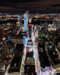 High angle view of city lit up at night