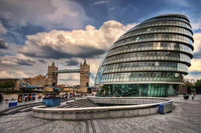 View of modern buildings against cloudy sky