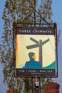 Low angle view of road sign against sky