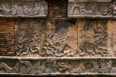 Low angle view of carvings on brick wall