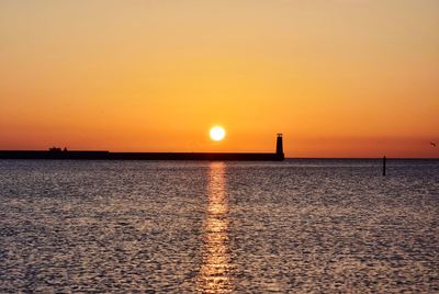 Scenic view of sea against romantic sky at sunset