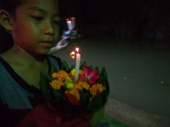 Portrait of boy with flowers in background