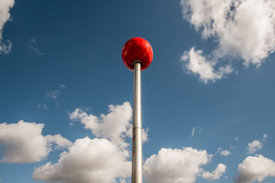 Low angle view of red light against sky