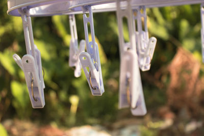 Close-up of clothespins hanging on clothesline