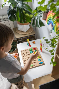 High angle view of boy using laptop on table