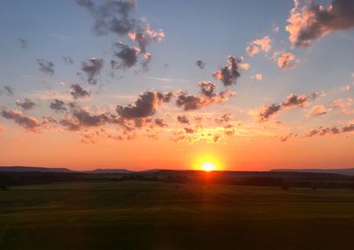 Scenic view of sunset over land