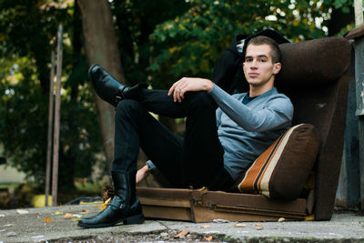 Portrait of young man sitting outdoors
