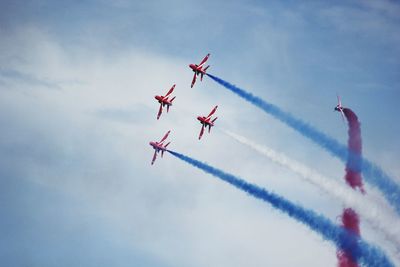 Low angle view of airshow in sky