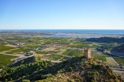 Almenara, spain. old watchtower, orange-tree fields, wetlands and the mediterranean sea.