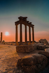 Old ruins of temple against sky during sunset